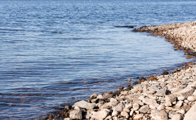 Rocky shore and water surface. The coastline.