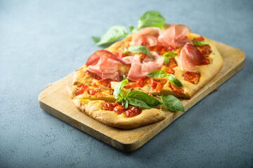 Homemade focaccia with tomatoes and ham