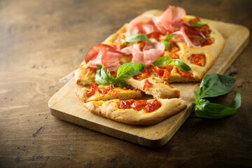 Homemade focaccia with tomatoes and ham