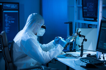Microelectronics engineer works in a modern scientific laboratory on computing systems and...