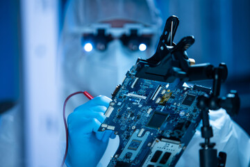 Microelectronics engineer works in a modern scientific laboratory on computing systems and...