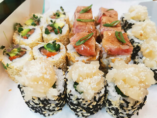 Delicious sushi rolls in a disposable box. Japanese food delivery