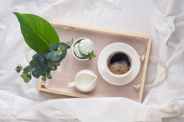 Breakfast in bed. Tray with coffee, marshmallows on a white background.