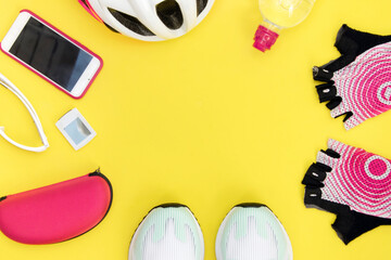 Bike accessories on a bright yellow background with an empty space.