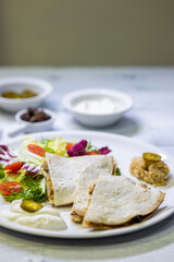 chicken quesadilla with rice, beans, salad, chalapenos and salsa