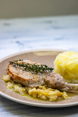 pork chop with thyme baked on creamy onion with mashed potatoes