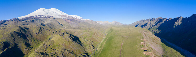 Panoramic aerial view of mount Elbrus from the north. Prielbrusye National Park, Kabardino-Balkaria, Caucasus, Russia.