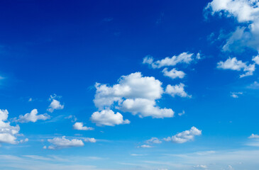 Naklejka na ściany i meble Blue sky background with tiny clouds. fluffy clouds in the sky. Background summer sky