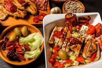 Grilled chicken breast and vegetable salad. Diet food for athletes. Healthy food. Chicken steak with tomatoes.