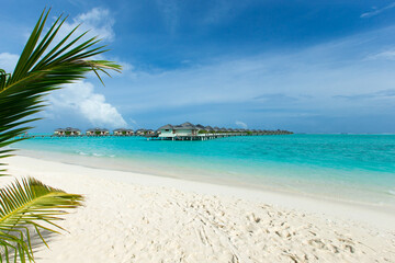 Beautiful tropical Maldives island with beach. Sea with water bungalows