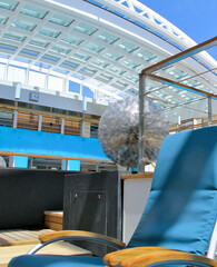 Indoor swimming pool and whirlpool solarium with opened skylight roof and deck chairs sun loungers...