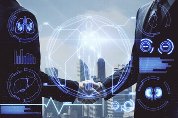 Double exposure of education theme hologram and handshake of two men.