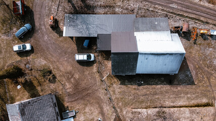 Warehouse with cars outside of a farming property