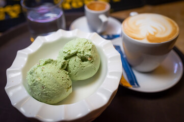 coffee and ice cream. coffee break with ice cream. pistachio ice cream and coffee served an a tray.