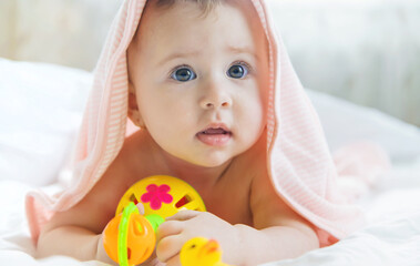 Baby after bathing in a towel. Selective focus.