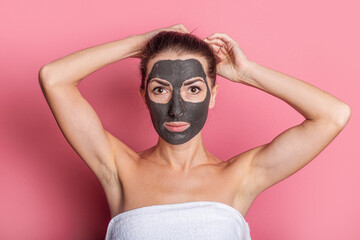 young woman with bare shoulders with a face peeling mask. Spa treatments