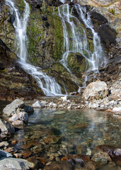 View of waterfall near by Sophia lakes on sunny summer day. Arkhyz, Karachay-Cherkessia, Russia.