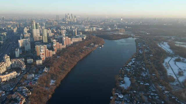 sunset over the city, tall skyscrapers, urban contrast, winter cityscape, drone shooting of the city