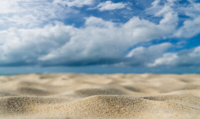 Fototapeta na wymiar sand dunes on the beach and blurred blue sky clouds background 