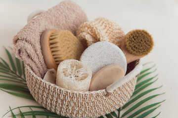 woven basket with natural body care products - sponge, towel, loofah, soap, body brush