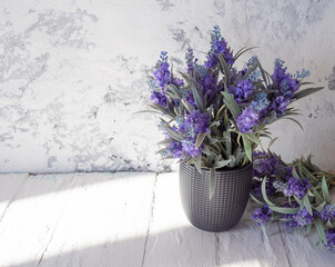 Laconic gray background with planters and lavender.
