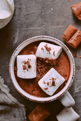 Hot chocolate and marshmallows. Hot Cocoa in a white cup. Dark background. Copy space. Steam from a cup. Top view