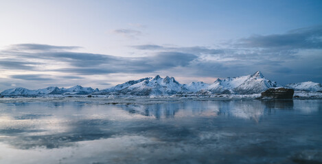 Fototapeta na wymiar Amazing seascape with snowy mountains at sundown