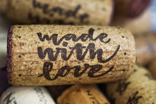 Close up of isolated natural wine cork with text made with love