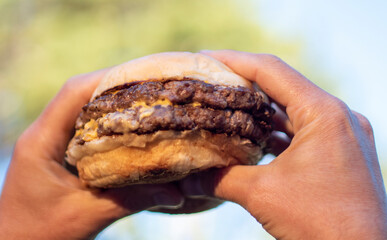 hand holding a burger