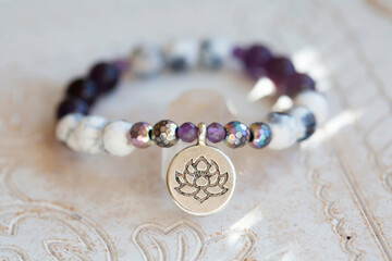 Mineral stone beads yoga bracelet on neutral natural background