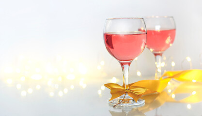 Pink wine in glasses on a light background and a place for text.