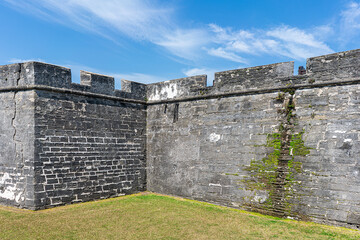 Fototapeta na wymiar Ancient limestone fort wall against blue sky
