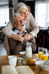 Smiling senior couple sitting outside at sunset