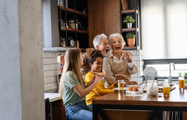 Multigeneration multiethnic grandparents with grandchildren in kitchen