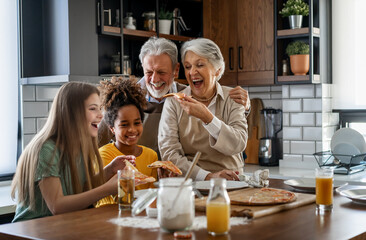 Multigeneration multiethnic grandparents with grandchildren in kitchen