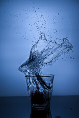 A glass of water with splash against white background