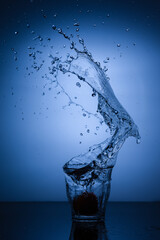 A glass of water with splash against white background