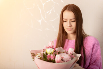 Congratulation happy birthday, anniversary, easter, bouquet of flowers in the hands of a girl