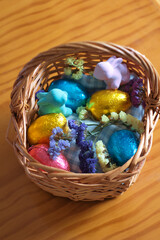 Basket with easter eggs, bunnies and flowers.