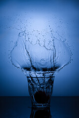 A glass of water with splash against white background