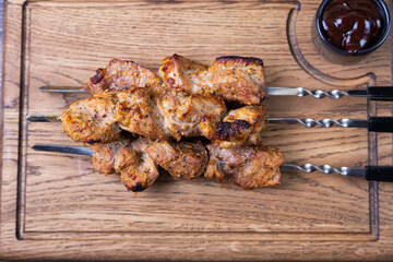 Traditional Russian shashlik on skewers. Grilled pork meat (shish kebab). Close-up, top view.