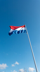 Dutch flag on blue sky