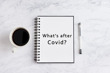Notebook on desk written what's after covid