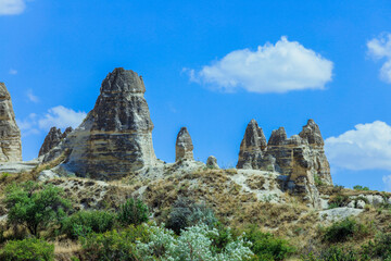 Fototapeta na wymiar Fantastic View to the Göreme with rock houses in front of the spectacularly coloured valleys nearby, Cappadocia, Turkey