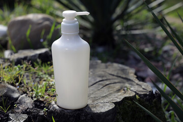 white plastic bottle on green grass background