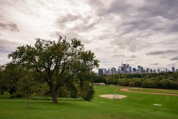 Riverdale park in Toronto on a cloudy day with a skyline of the city of Toronto in the background