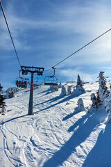 Fototapeta na wymiar Empty ski chair lift on a mountain - season with no tourists.