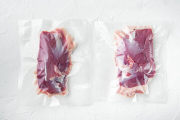 Duck breast, raw freshly slaughtered by the bio farm prepared for vacuuming and smoking, on white stone  background, top view flat lay