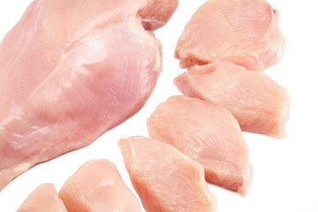Fresh raw chicken breast fillet whole and sliced isolated closeup on white background, clipping path