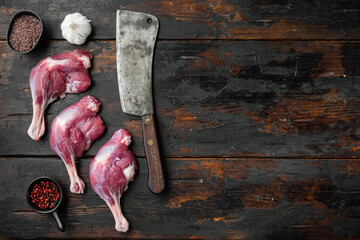 Duck leg thighs confit poultry meat raw Menu concept serving size  with old butcher cleaver knife, on old dark  wooden table background, top view flat lay, with copyspace  and space for text